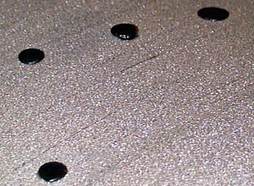 Melted-over plastic rivets